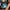 Person with headphones on, focused on playing Dota on a screen in front of them