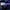 OpenAI Five competitive event in a large, dim venue with bright spotlights and a large audience